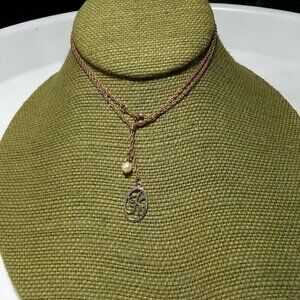 Women`s gold tone faux pearl k initial necklace.